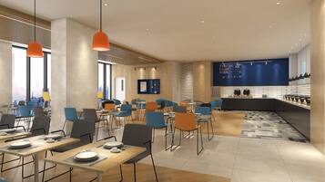 A modern dining area with tables, chairs, and pendant lighting.
