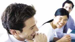 A person in a white shirt and black tie sitting at a desk with papers, in an office setting. - Holiday Inn Express Guilin City Center by IHG (Guilin)