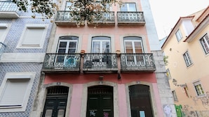 A building with three floors, each with a balcony featuring ornate wrought iron railings. - Bairro Alto Views by Homing (Lisbon)
