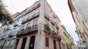 A narrow street with buildings featuring balconies and a sign that reads "Casa de Baluartes." - Bairro Alto Views by Homing (Lisbon)
