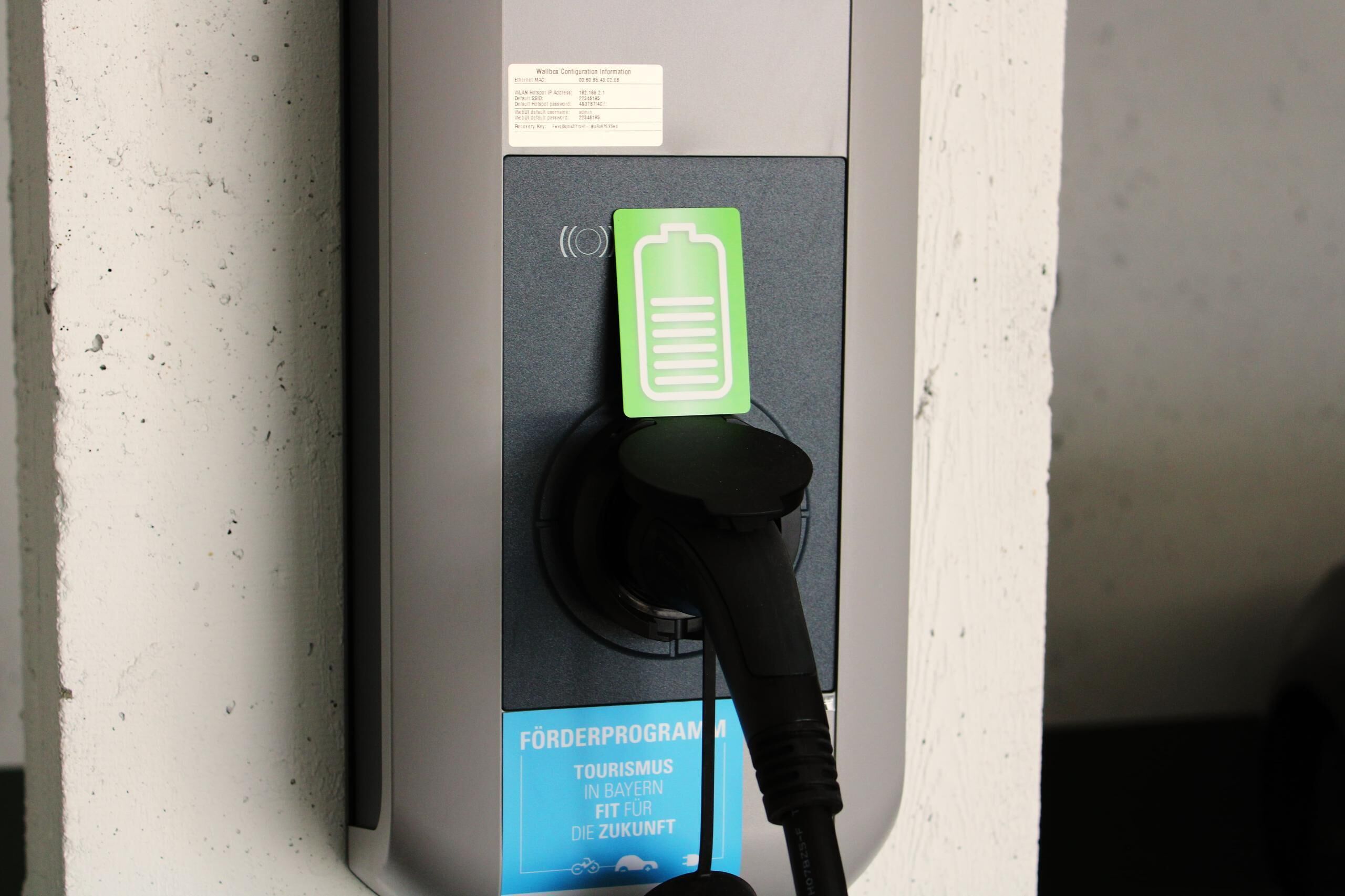 A charging station with a green battery icon and a plug.
