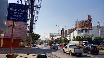 Una calle concurrida con el cartel del Hotel City Park.