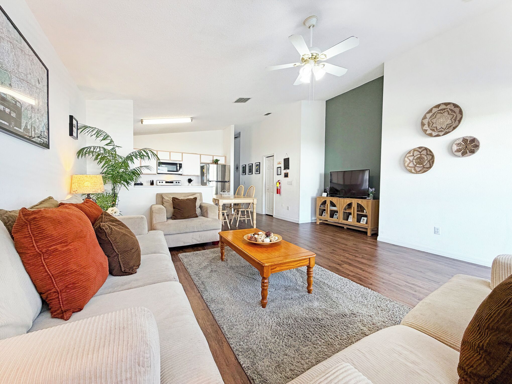 A modern living room with a sofa set, a wooden coffee table, and a TV stand.