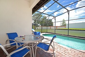 Relax by the pool in a tranquil outdoor space with a clear view of the surrounding landscape.