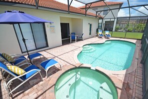 Relax by the pool surrounded by a patio and a clear view of the adjacent building.