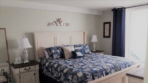 A bedroom with a bed, nightstands, a dresser, and a window with curtains. - DIRECT BEACHFRONT - PENTHOUSE CORNER UNIT!!  Totally Renovated! (Indian Shores)
