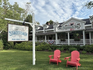 A hotel with a signboard for 'The Lake Placed Stagecoach Inn' and a telephone number. - Lake Placid Stagecoach Inn (Lake Placid)
