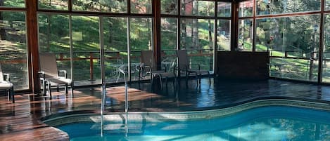 Indoor pool, open 9:00 AM to 9:00 PM, pool umbrellas