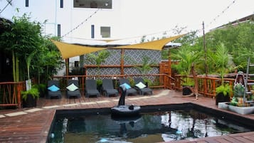 Outdoor pool, open 9:00 AM to 9:00 PM, pool umbrellas, pool loungers