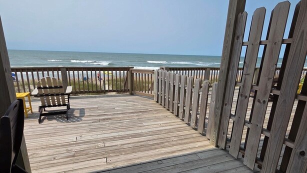 A wooden deck with a view of the ocean. - 3 bedroom 2 bathroom, pet friendly, ocean front duplex (Emerald Isle)