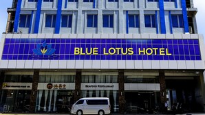 A multi-story hotel with a prominent blue and white facade, featuring a large sign for the Blue Lotus Hotel. - Blue Lotus Hotel Davao (Davao)