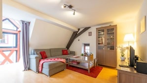 A cozy living room with a sofa, a coffee table, and a cabinet.