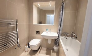 Combined shower/bathtub, hair dryer, towels, soap