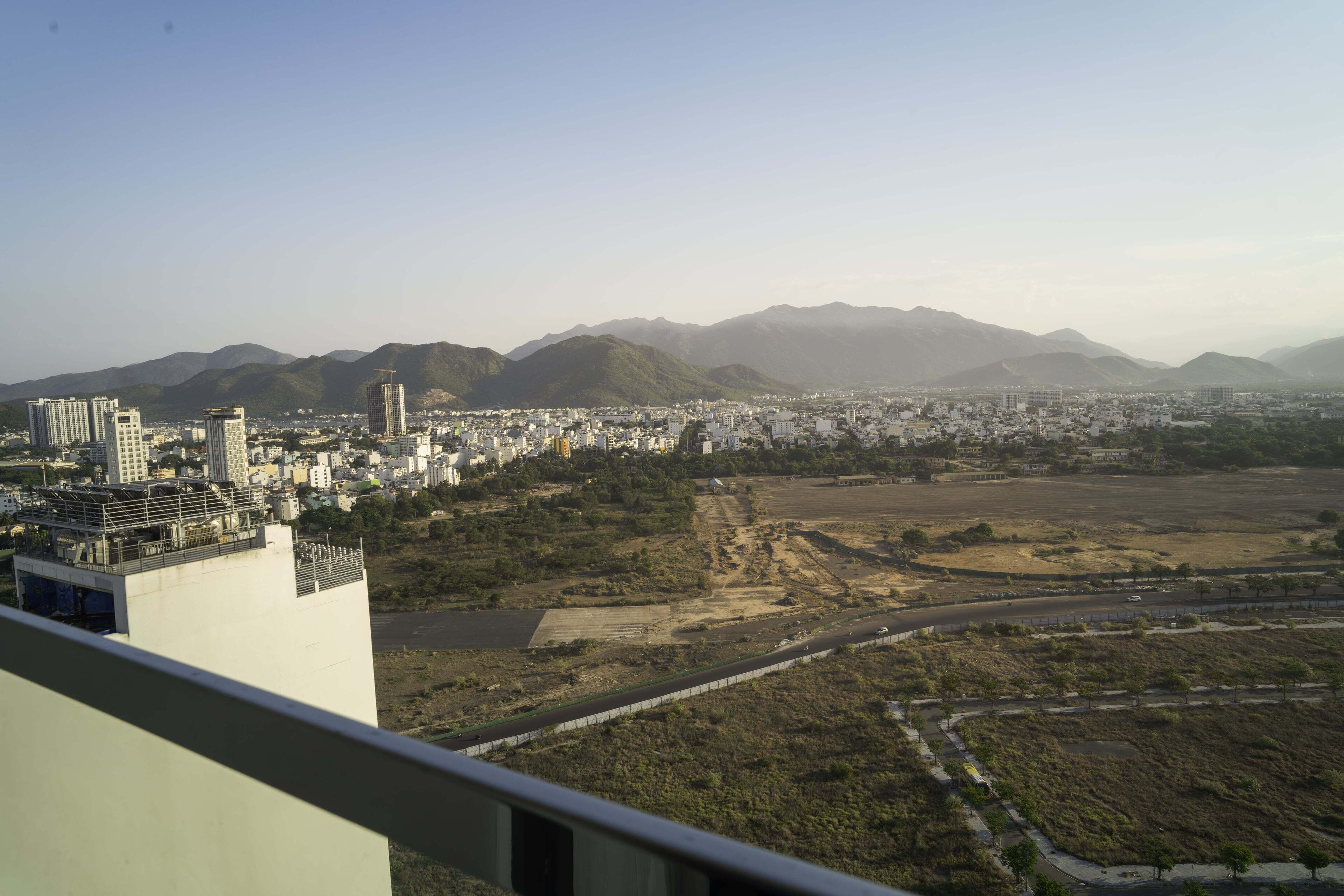 A cityscape with a view of mountains in the background.