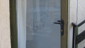 A door with a glass panel, a keyhole, and a handle. -  Good heavens 1, bed & bike, (Betina,Murter)