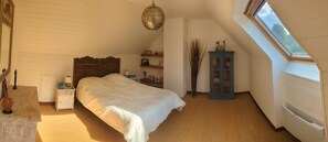 A bedroom with a large bed, a nightstand, a dresser, a cabinet, and a skylight. - Charming country house near Saint-Valery-Sur-Somme, 6 people (Arrest)