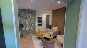 A modern living room with a sofa, armchair, and a small coffee table. - Charming country house near Saint-Valery-Sur-Somme, 6 people (Arrest)