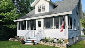 A two-story house with a porch, a small front yard, and an American flag. - Harbor House located in the heart of Ephraim! (Ephraim)