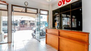 A reception area with a glass door entrance, a clock above the door, and a sign reading "OYO". - Collection O Mangga Besar Near Lokasari Square Formerly 45 Residence (Jakarta)