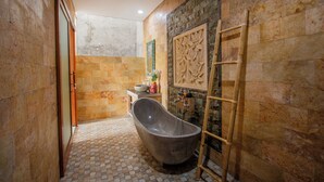 A bathroom with a freestanding bathtub, a wooden ladder, and a tiled floor. - Ubud Paras Villa (Ubud)