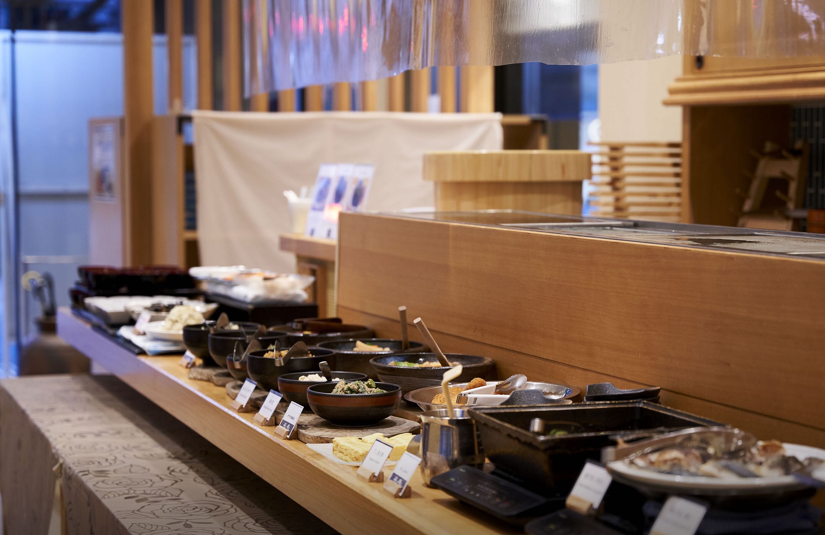 A buffet with various dishes and utensils.