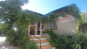 A building with a sign reading "Golden Days Executive Lodge." - Golden Days Executive lodge (Lusaka)