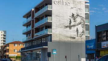 Experience the sleek Astina building, featuring contemporary architecture and balconies.