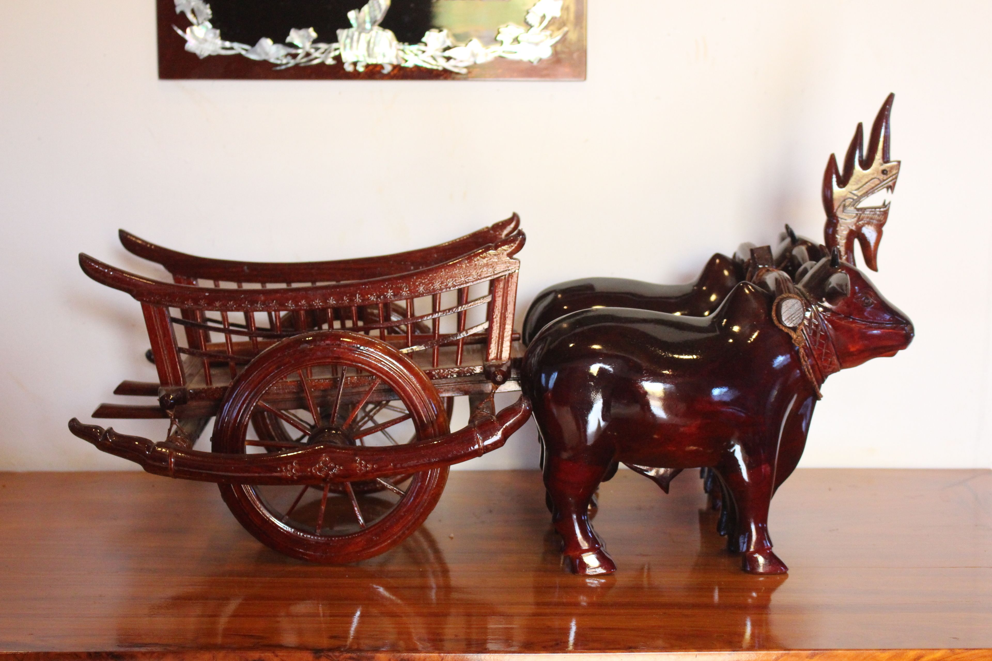 A wooden carriage with a horse figurine.