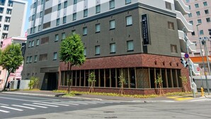 Un hôtel à plusieurs étages au design moderne, avec un logo bien visible sur sa façade.
