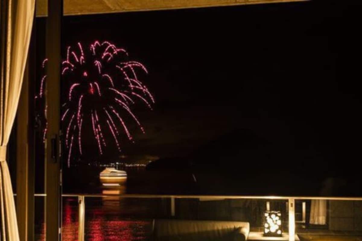 A room with a view of fireworks outside.
