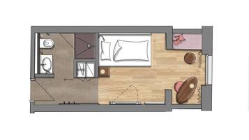 Een plattegrond van een hotelkamer met een bed, een badkamer, een zithoek en een kleine tafel.