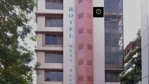 A multi-story building with the sign "HOTEL WEST BLUE" prominently displayed. - Hotel West Blue (Mumbai)
