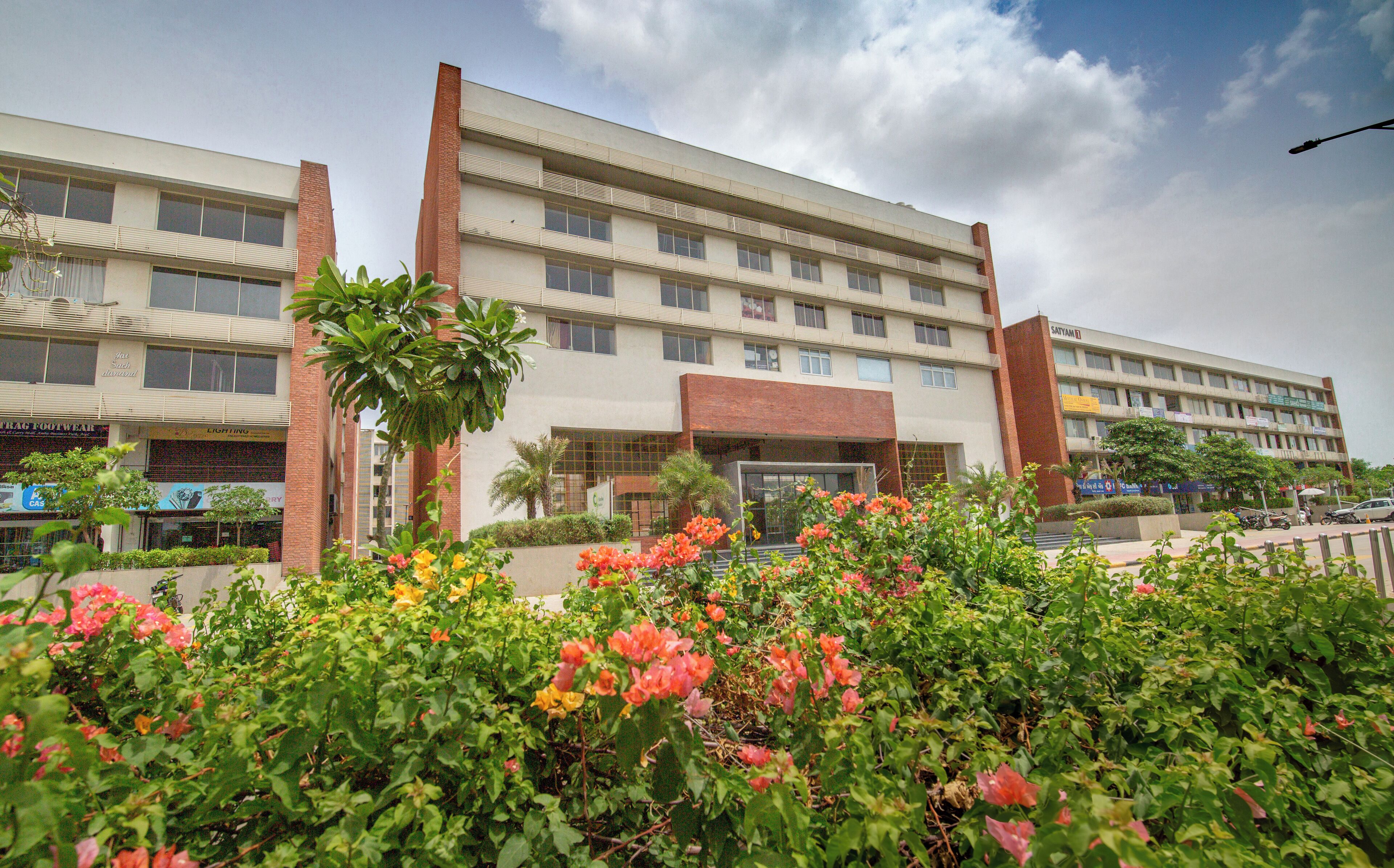 A multi-story building with a flat facade, large windows, and a central entrance.