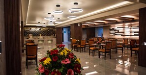 A hotel lobby with a reception desk, seating area, and modern lighting fixtures. - Siara Styles Amba Suites (Gandhinagar)