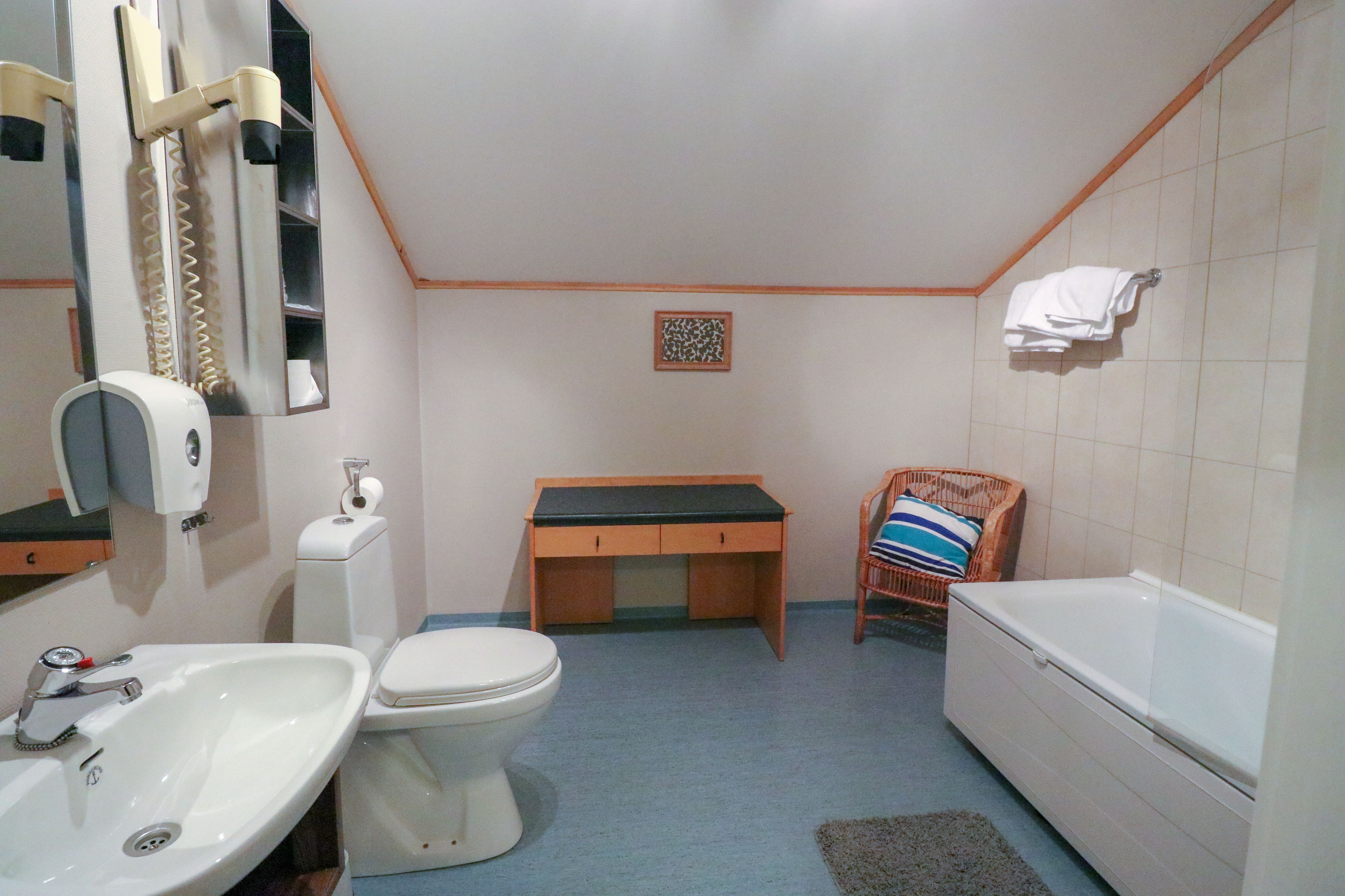 A bathroom with a sink, toilet, and bathtub.