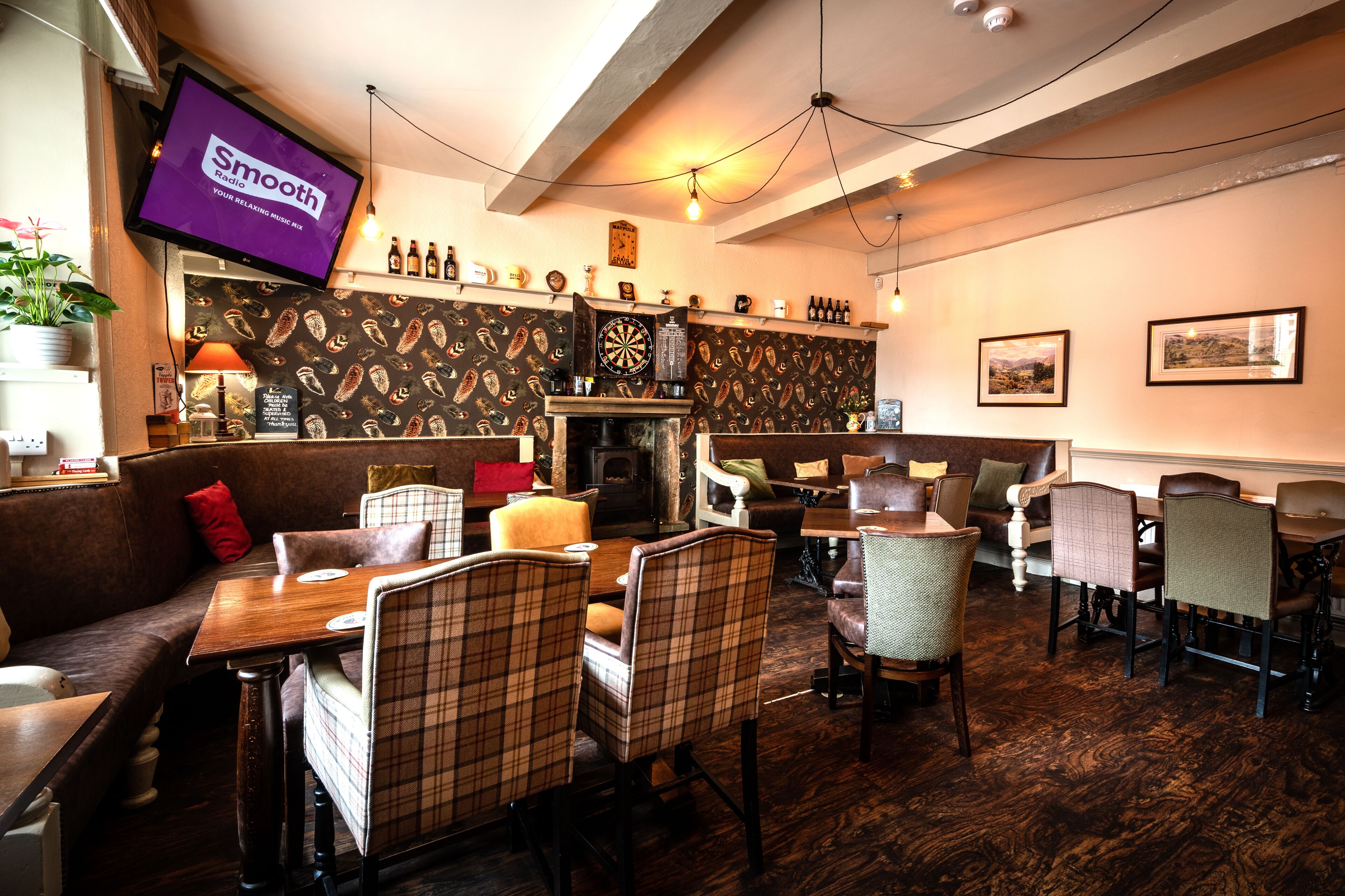 A cozy restaurant with a billiards table, wooden tables, and comfortable seating.