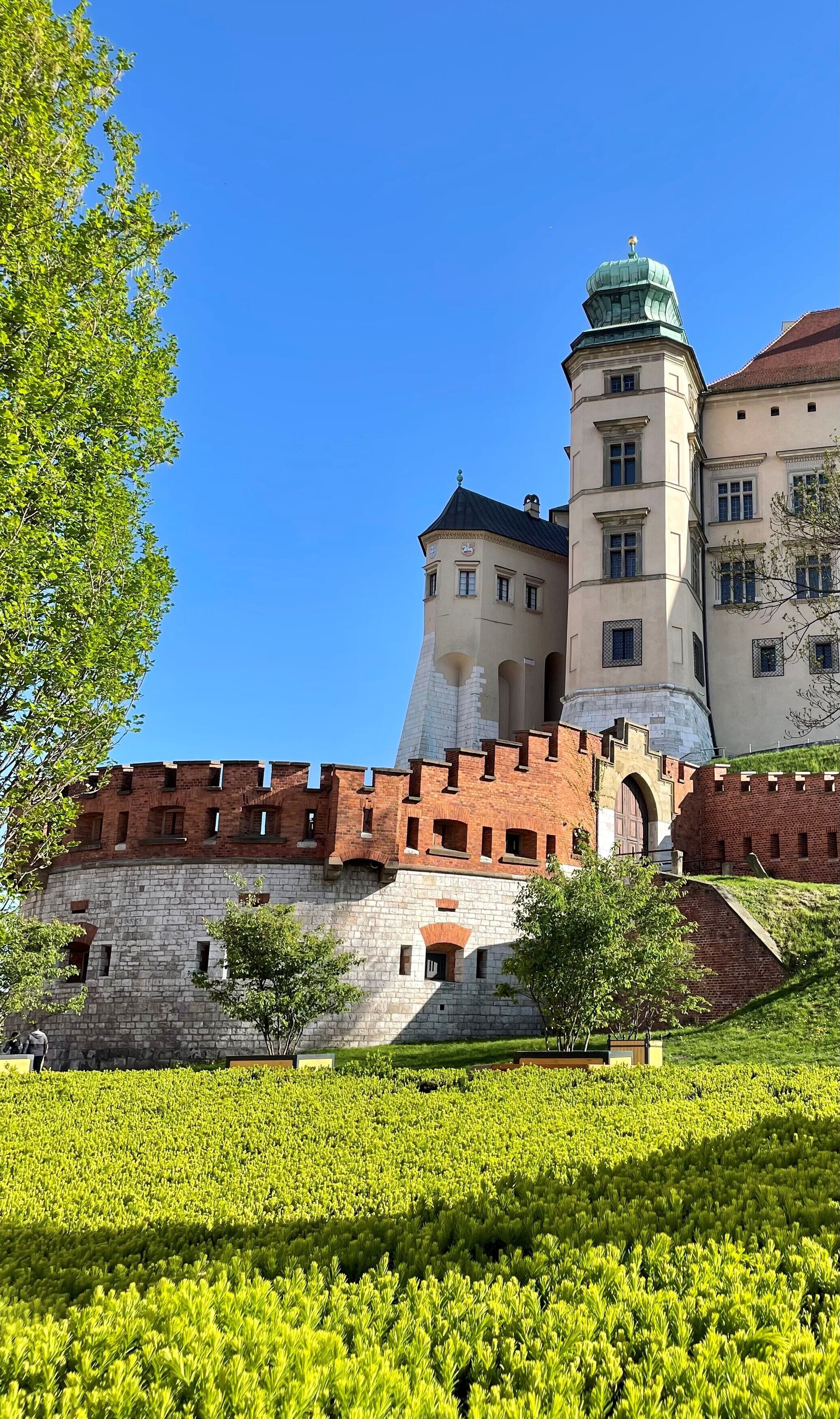 A historic building with a prominent tower and a fortified wall.