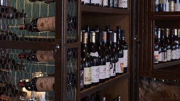 A wine cellar with shelves of wine bottles.