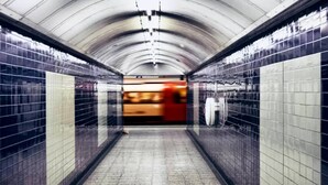 A subway station with tiled walls and a curved ceiling. - Luxury Mayfair 2 Bedroom Apartment (London)