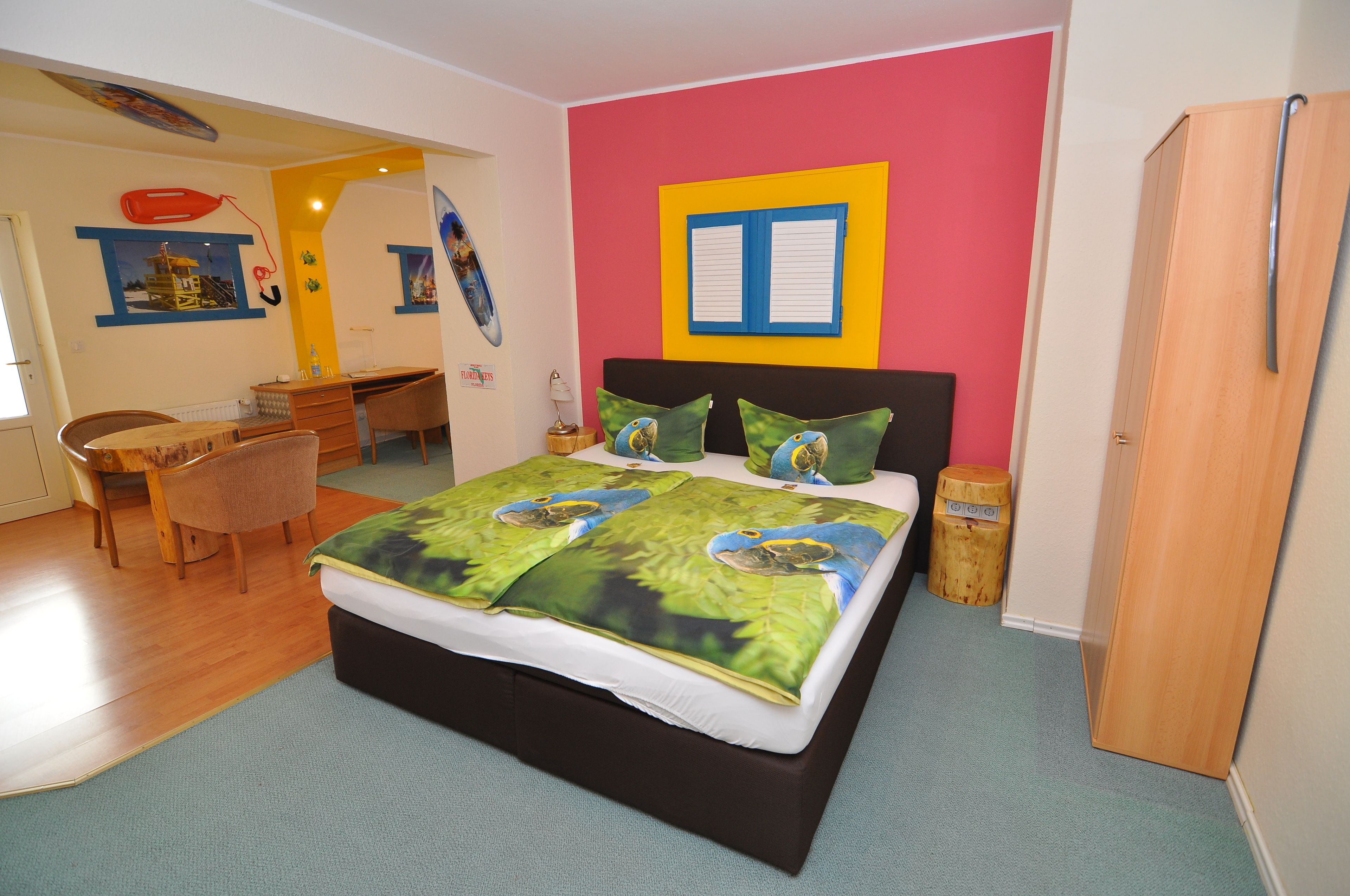 A bedroom with a bed, a desk, and a chair.