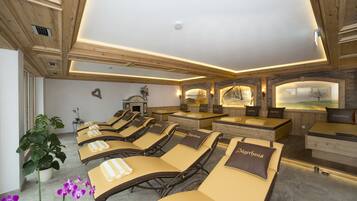 Experience serene relaxation in this spa room, featuring massage tables, towels, and a calming ambiance.