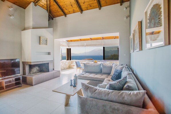 Villa | Living area | Flat-screen TV, fireplace
