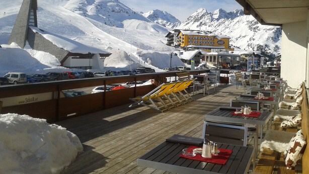 A snow-covered mountain with a ski lift and buildings in the background. - Alpenhotel Seiler (Silz)