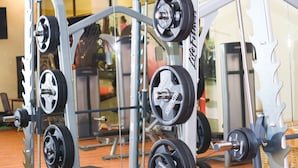 A gym with weightlifting equipment, including barbells and weight plates. - Verona Hotel & Conference Center (Ruiru)