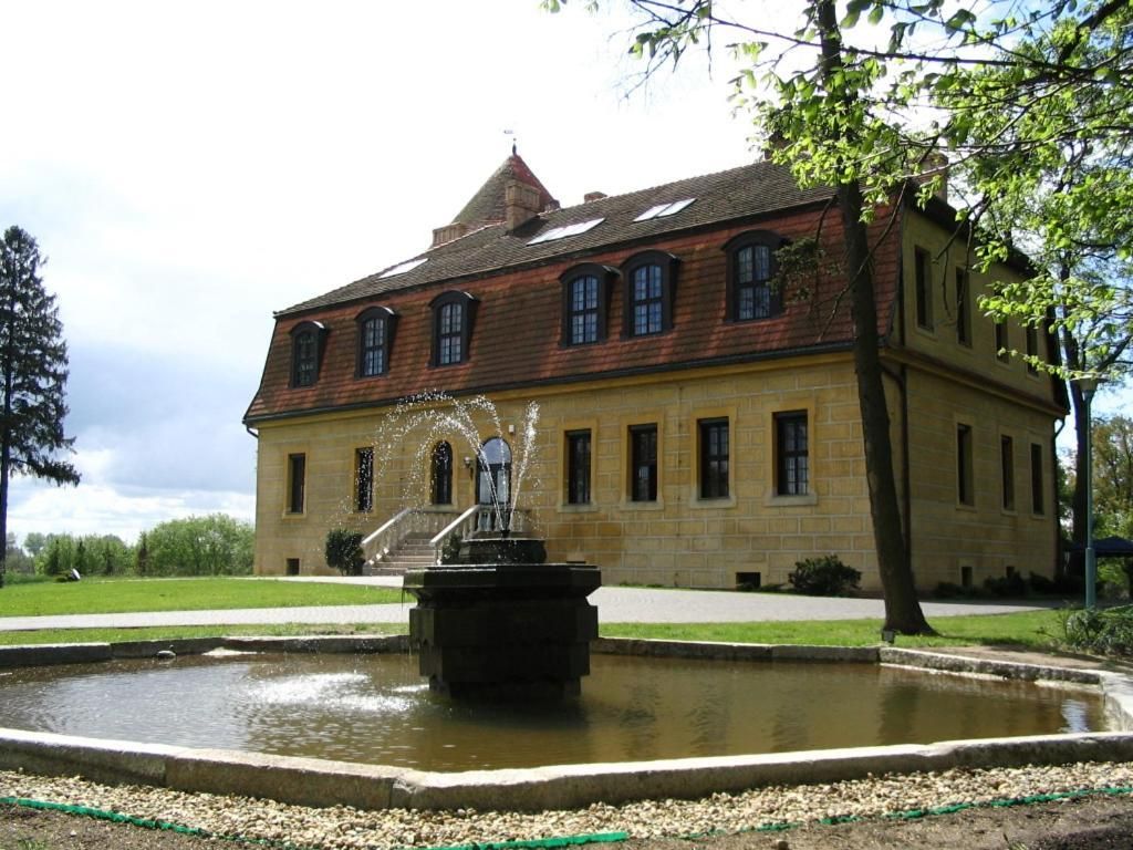 A historic building with a fountain in front.
