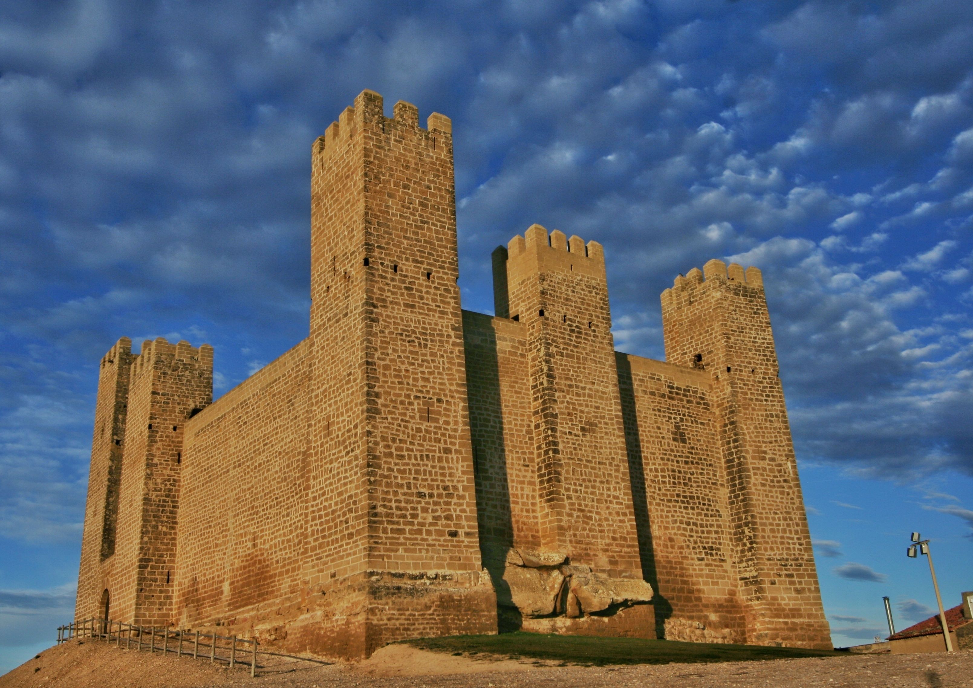 A large stone castle with multiple towers and a fortified wall.
