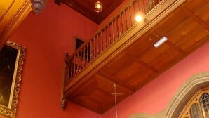 A grand staircase with ornate railings and a large, ornate balustrade. - Tillmouth Park Country House Hotel (Cornhill on Tweed)
