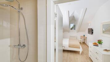 Shower, rainfall showerhead, hair dryer, towels