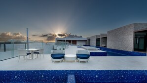 A rooftop pool area with seating and a view of the sunset. - Trendy 1BR Apartment in Cruz con Mar brand new building by Happy Address (Playa del Carmen)
