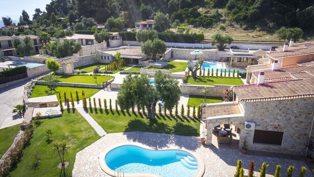 A residential area with multiple houses, a swimming pool, and a well-maintained garden. - Nefeli Luxury Villas (Kassandra)